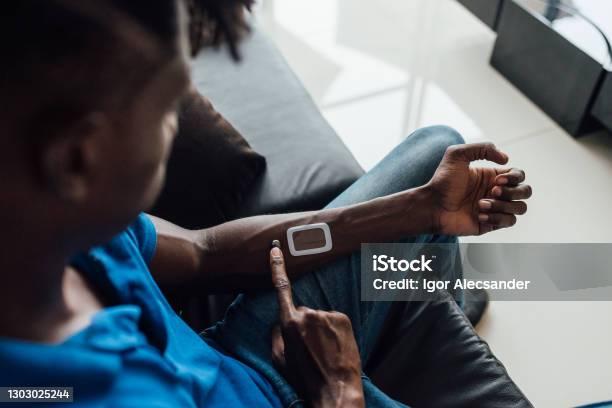 Man Using Futuristic Device On His Arm Stock Photo - Download Image Now - Implant, Healthcare And Medicine, Computer Chip