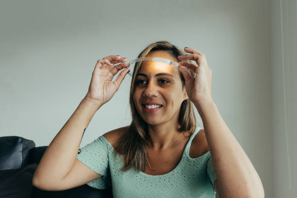 istock Smiling woman putting a smart device on her head (futuristic) 1303025474