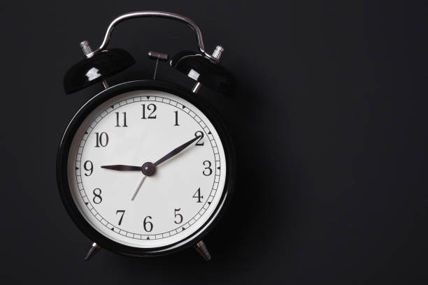 istock Alarm clock on a black background in Low-key lighting 1303025673