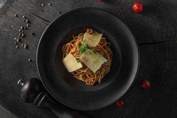 istock Pasta bolognese Italian on black plate 1303026552