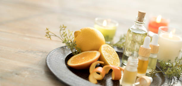 Essential Oils with Oranges, Lemons and Candles Essential Oils with Oranges, Lemons and Candles. aromatherapy oil photos stock pictures, royalty-free photos & images