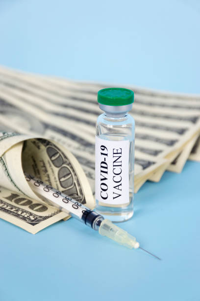 istock Covid-19 vaccine and money 1303026844