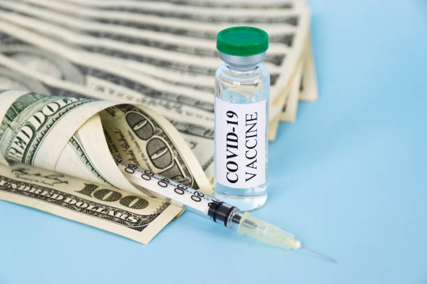 istock Covid-19 vaccine and money 1303026856