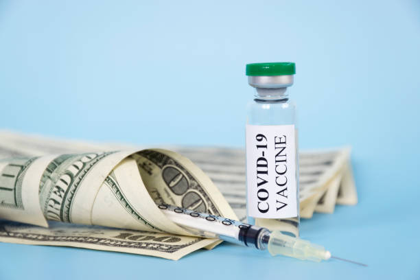 istock COVID-19 vaccine vial and money 1303026859