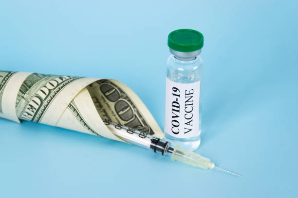 istock COVID-19 vaccine vial and money 1303026867