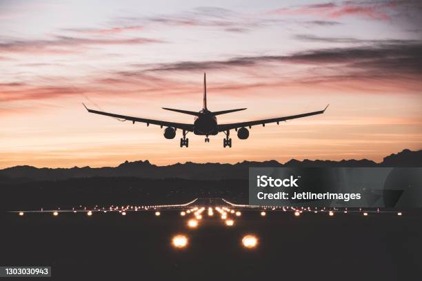 Aircraft Landing At Sunrise Stock Photo - Download Image Now - Airplane, Taking Off - Activity, Landing - Touching Down