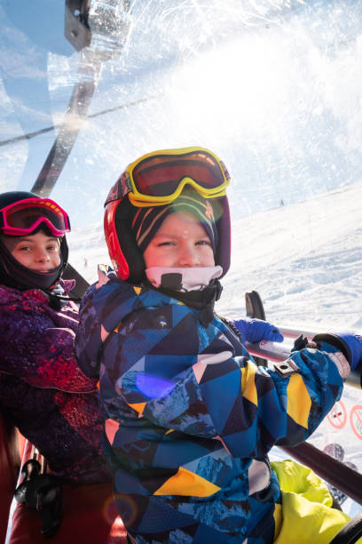 istock Kids sitting on a ski lift 1303031956