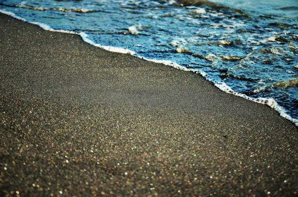 The black monastic sand in the late afternoon on mococa beach on the north coast