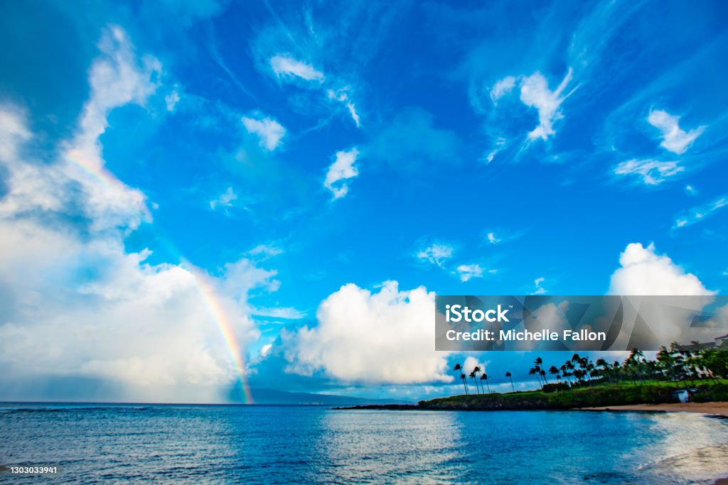 Colorful morning sky in Maui Beautiful colors shining early morning over West Maui Rainbow Stock Photo