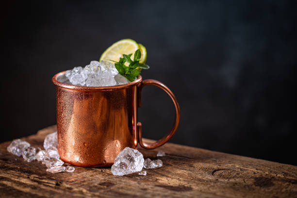 Moscow Mules cocktail Icy cold Moscow Mules cocktail with ginger beer and vodka on dark background mule stock pictures, royalty-free photos & images