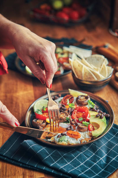 istock Mexican Style Breakfast with Eggs, Mushrooms, Beans, Tomatoes, Avocado and Tortilla 1303037505