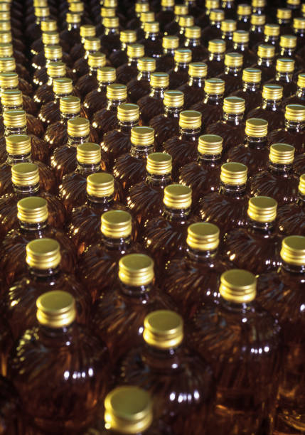 istock Corn oil bottles in conveyor belt 1303038654