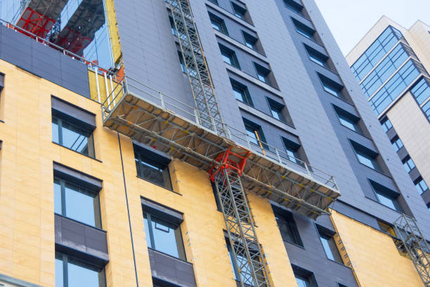 istock Construction elevator cradle, building glazing, for finishing the external facade of a multi-storey building. 1303039145