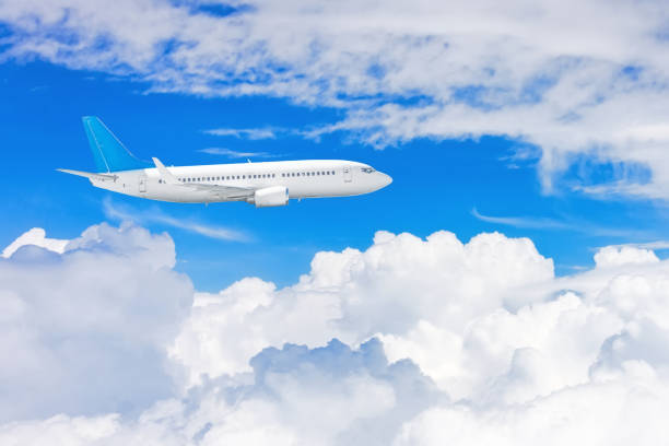 istock Flying a aircraft over fluffy cumulus clouds, aerial view. 1303039176