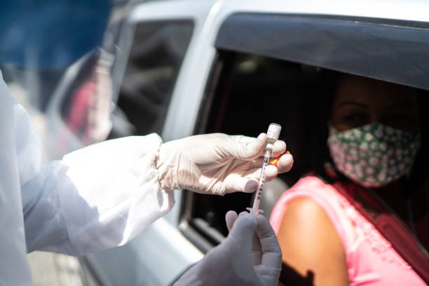 Doctor preparing vaccine at the drive through Doctor preparing vaccine at the drive through drive through photos stock pictures, royalty-free photos & images