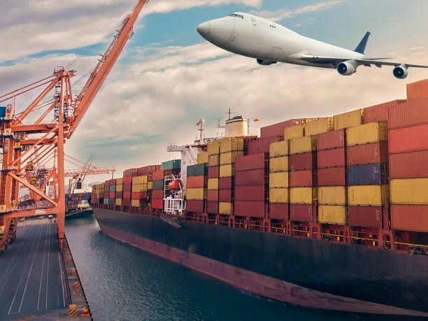 istock Airplane flying above the container ship. Transportation concept. 1303044096