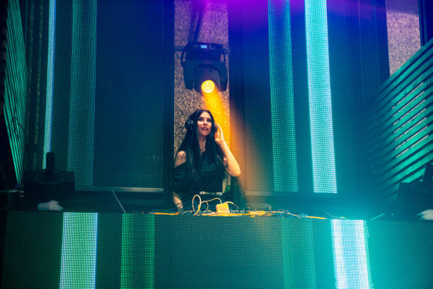 istock DJ on stage in disco night club mixing techno music beat 1303047237