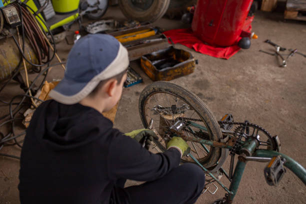 istock Little boy fixing his bike 1303047392