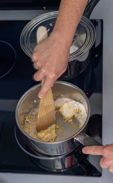 istock Paris, France - 02 14 2021: Preparation of lasagna with meat, spinach, tomatoes and bechamel 1303047592