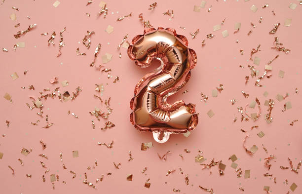 istock Shiny balloons with glitters on festive background. 1303048731