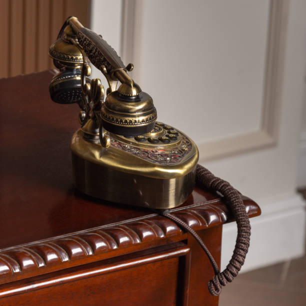 istock Restored vintage phone standing on the wooden table 1303048865