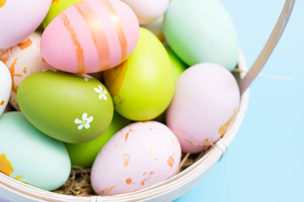 istock Easter basket filled with painted Easter eggs. Colorful painted Easter eggs in basket. 1303052736