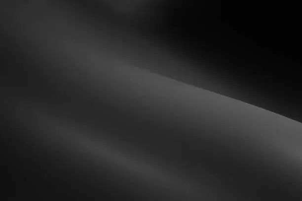 Photo of abstract background with smooth waves in shades of black