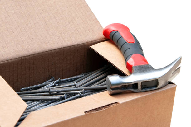 istock A hammer and nails in a cardboard isolated on white background. Tools for fixing. Home repair 1303053718