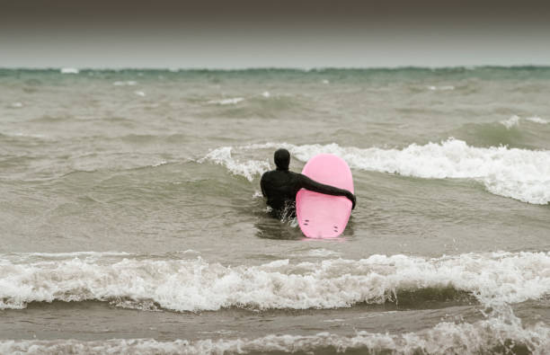 istock Young woman during winter surf 1303056566