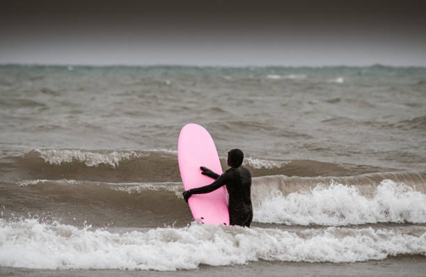 istock Young woman during winter surf 1303056680