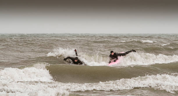 istock Young couple during winter surf 1303056710