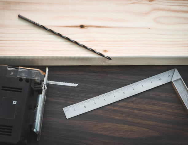 istock Wood processing to product with jigsaw, drill and ruler tools. 1303056761