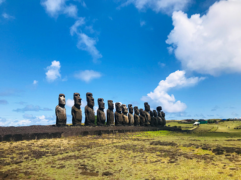 A group of Moais statues at Ahu Tongariki, Easter Island National Park, Easter Island (Isla de Pascua), Rapa Nui, Chile, Latin America in a sunny summer blue day.\n\nVisiting and sightseeing Latin America destination.\n\nLatin America / Chile / Rapa Nui travel concept.