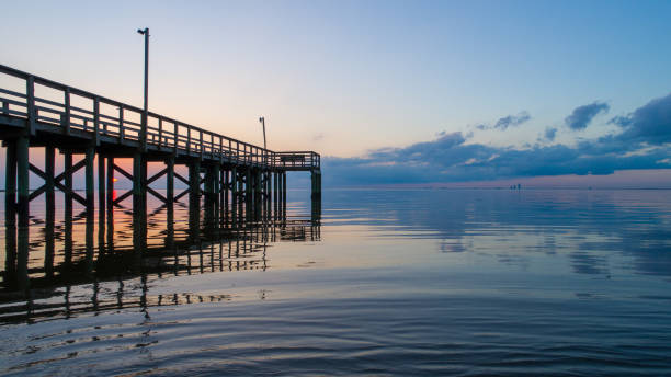 Calm Bay Sunset Tranquil sunset on Mobile Bay in February of 2021 mobile bay stock pictures, royalty-free photos & images