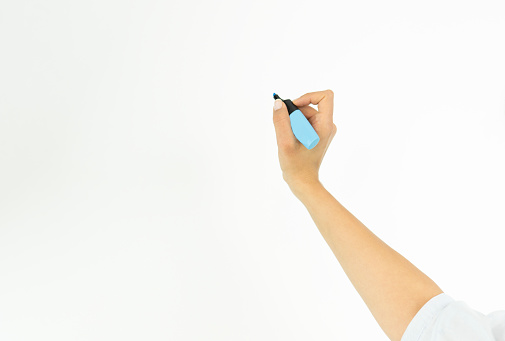 Cropped hand of business woman writing on whiteboard during meeting at creative Office