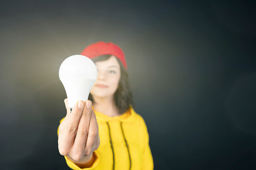 Woman holding light bulb in hand. innovative idea concept
