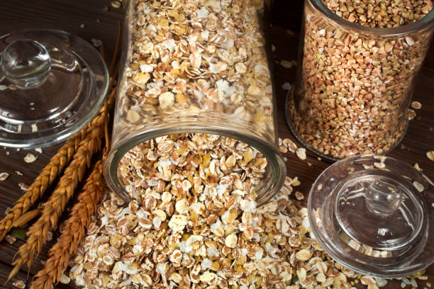 istock Green buckwheat and oat flakes with wheat ears 1303070581