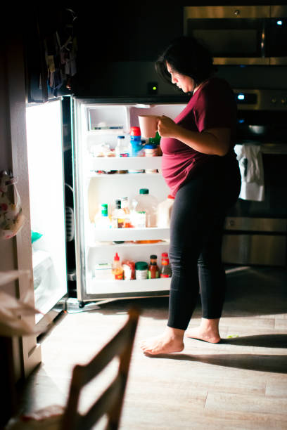 istock Pregnant Woman Getting A Snack at Midnight 1303073856