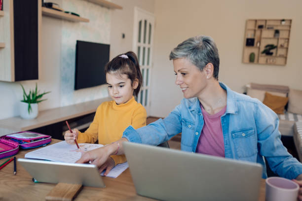 istock Mother working from home and teaching her daughter 1303075477