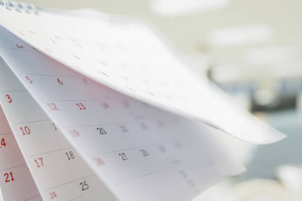 istock Calendar page flipping sheet close up on office table interior background business schedule planning appointment meeting concept 1303075496