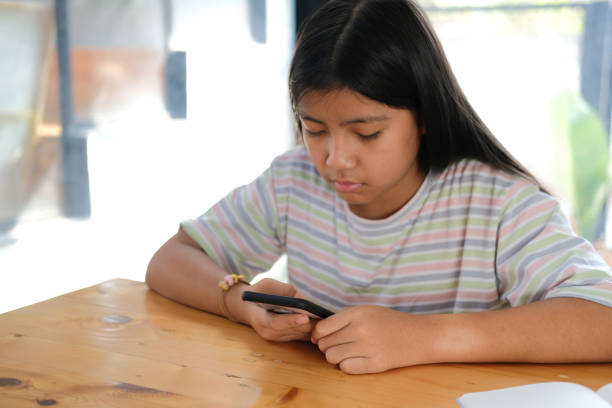 istock girl student using social media online app on smart mobile phone in library 1303075786
