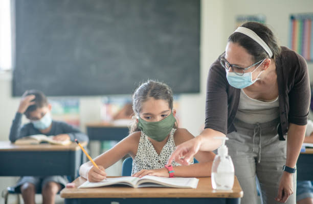 istock Wearing a mask in a classroom to keep everyone safe 1303075990