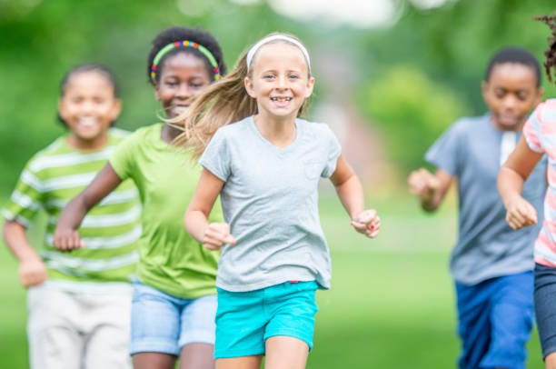istock Multi ethnic group of children running at a park 1303076002