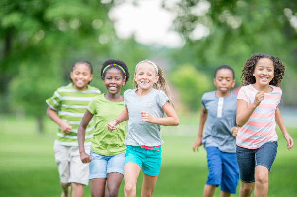 istock Multi ethnic group of children running at a park 1303076011