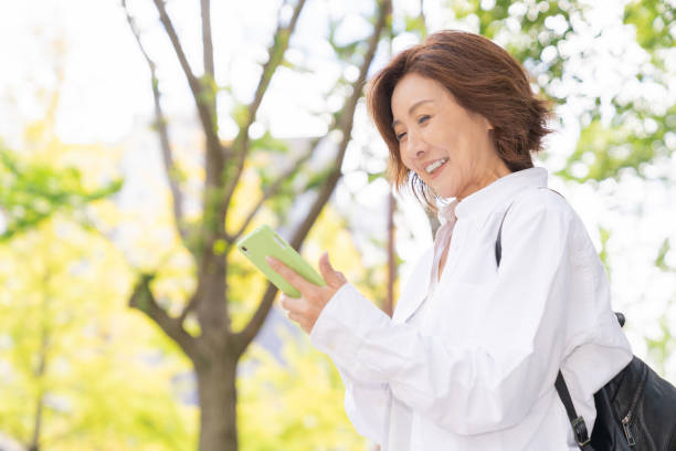 senior age woman who uses smart phone