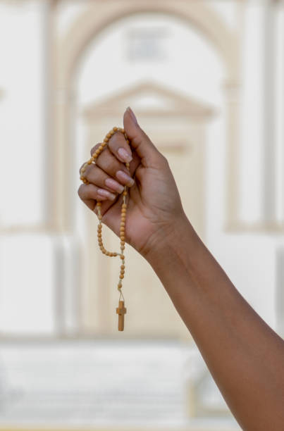 istock Female hand holding a catholic rosary 1303082081