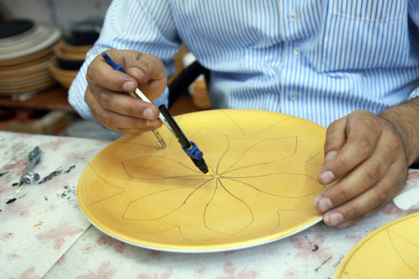 istock Ceramic artist drawing on traditional Turkish jug 1303082270
