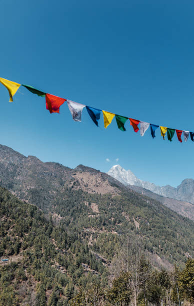 istock Prayer flags against blue sky, Himalayas, Nepal 1303082857