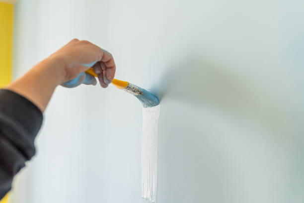 istock Brush with blue paint indoor. 1303083523