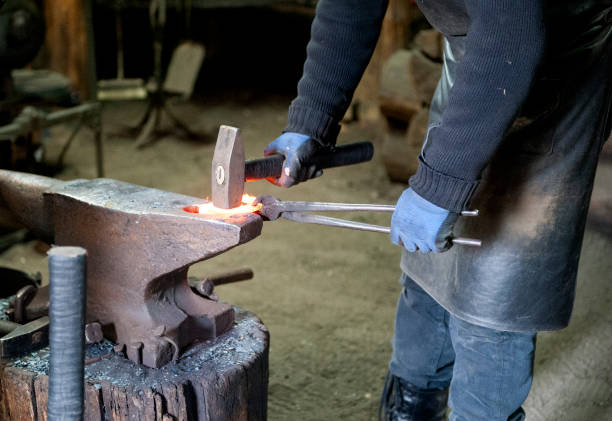 istock A blacksmith forges iron parts. A man at work. Forge, hot metal 1303086425